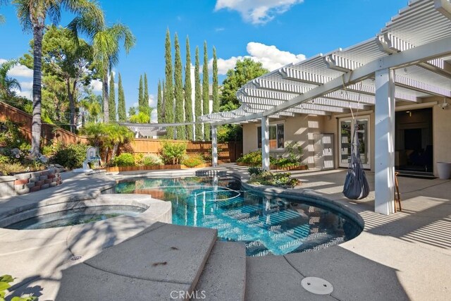 view of pool with a pergola, an in ground hot tub, and a patio