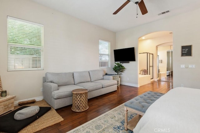 living room with ceiling fan and dark wood-type flooring