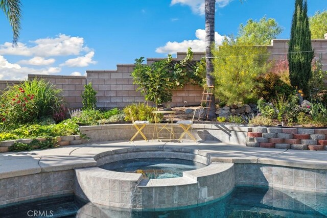 view of swimming pool featuring an in ground hot tub