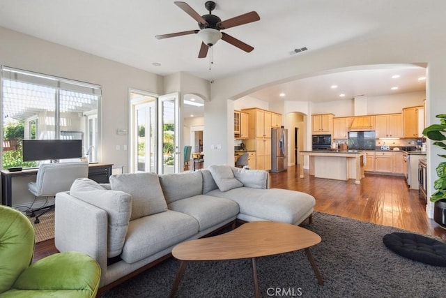 living room with wood-type flooring and ceiling fan