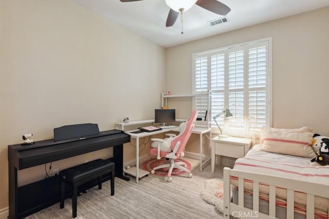 home office featuring ceiling fan and light carpet