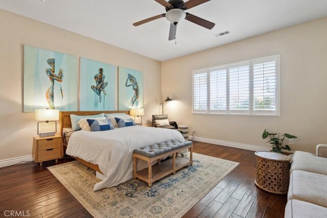 bedroom with dark hardwood / wood-style floors and ceiling fan