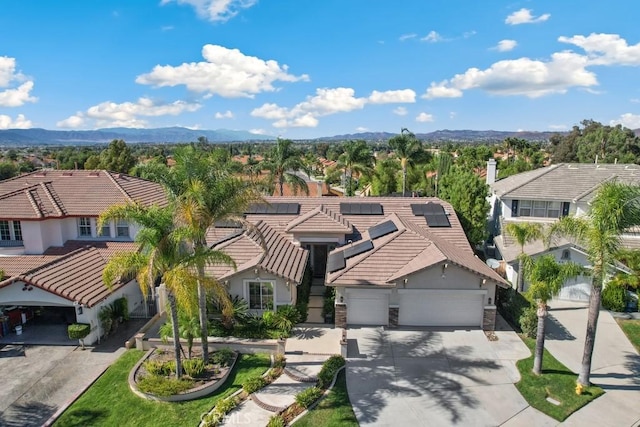 view of front facade featuring a mountain view and a garage