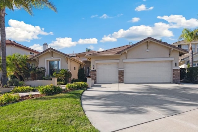 ranch-style house featuring a garage and a front lawn