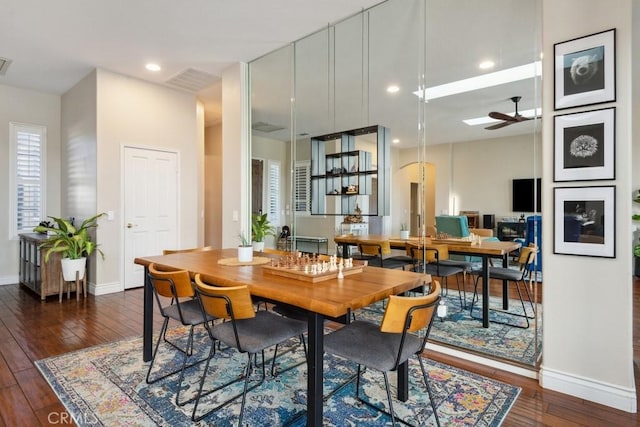 dining area featuring ceiling fan and dark wood-type flooring