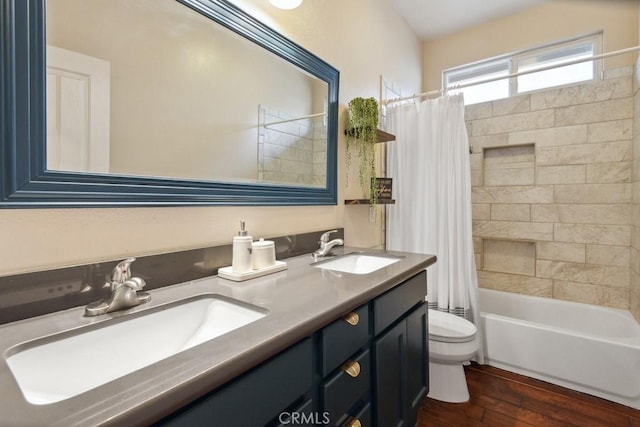 full bathroom with hardwood / wood-style flooring, vanity, toilet, and shower / tub combo with curtain