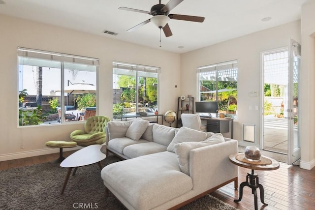 living room with ceiling fan and hardwood / wood-style floors