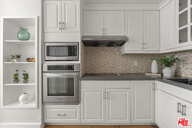 kitchen featuring appliances with stainless steel finishes, tasteful backsplash, and white cabinetry