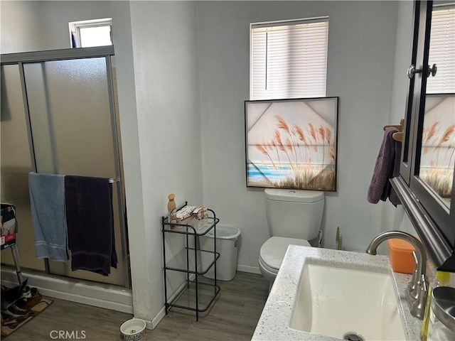 63737 Gibson Rd, Joshua Tree, CA 92252 - full bathroom with wood finished floors, a stall shower, toilet, and baseboards
