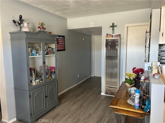 63737 Gibson Rd, Joshua Tree, CA 92252 - hall featuring a heating unit, wood finished floors, baseboards, and a textured ceiling