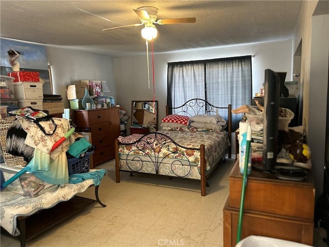 63737 Gibson Rd, Joshua Tree, CA 92252 - bedroom with tile patterned floors, a textured ceiling, and ceiling fan