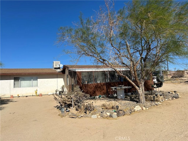63737 Gibson Rd, Joshua Tree, CA 92252 - back of house featuring stucco siding and central air condition unit