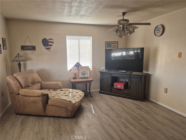 63737 Gibson Rd, Joshua Tree, CA 92252 - living area with wood finished floors, ceiling fan, and a textured ceiling