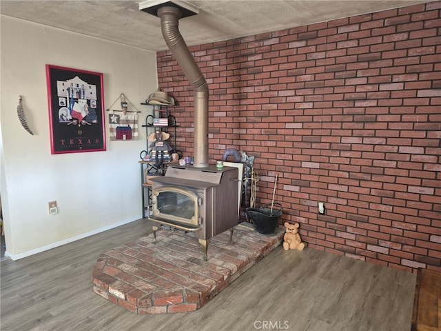63737 Gibson Rd, Joshua Tree, CA 92252 - detailed view of a wood stove, wood finished floors, and brick wall