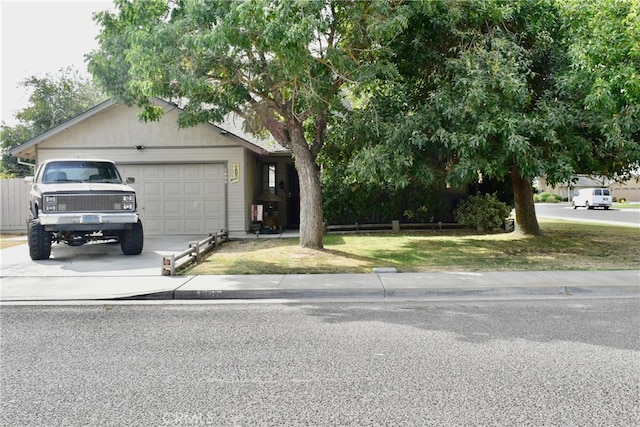 view of front of home featuring a front lawn and a garage