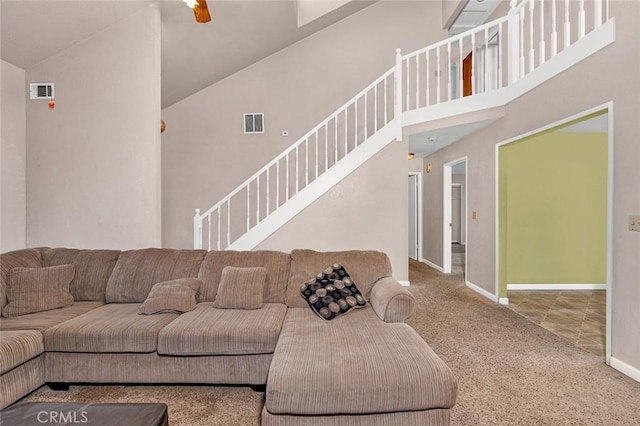 living room with high vaulted ceiling, carpet, visible vents, and baseboards