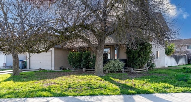 view of property hidden behind natural elements with a front lawn