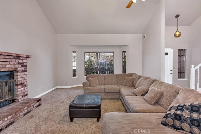 carpeted living area with a brick fireplace, baseboards, high vaulted ceiling, and a ceiling fan