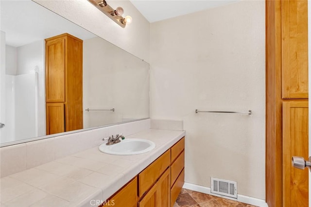 full bath featuring baseboards, visible vents, and vanity