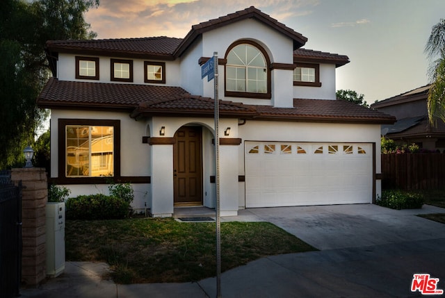 mediterranean / spanish-style home featuring a garage