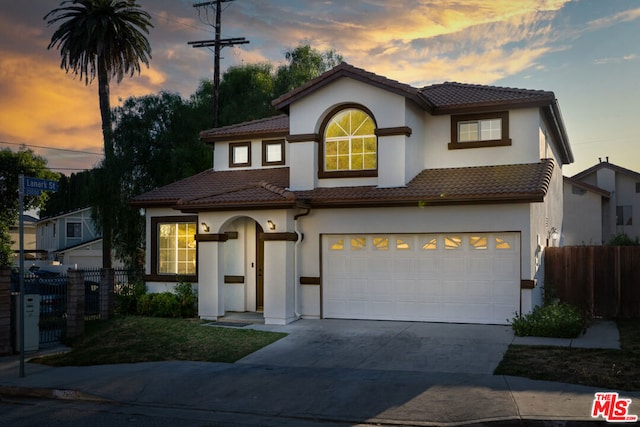 mediterranean / spanish house featuring a garage