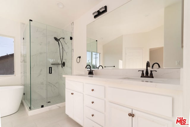 bathroom with tile patterned flooring, shower with separate bathtub, and vanity