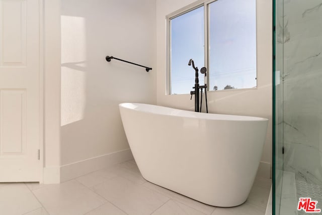 bathroom with tile patterned flooring, shower with separate bathtub, and a wealth of natural light