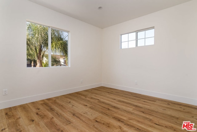 spare room with hardwood / wood-style floors