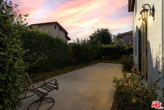 view of patio terrace at dusk