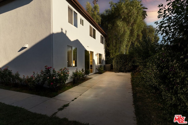 property exterior at dusk with central air condition unit