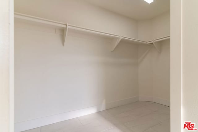 spacious closet featuring tile patterned flooring