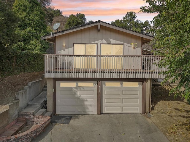 view of front of home with a balcony and a garage