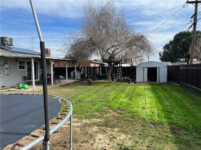 view of yard with a patio area and a storage shed