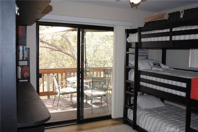 bedroom with multiple windows and light hardwood / wood-style floors