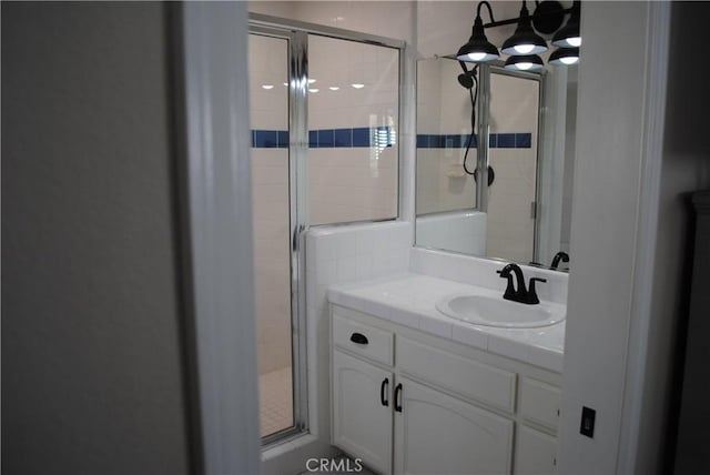 bathroom featuring vanity and an enclosed shower