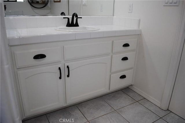 bathroom featuring tile patterned flooring and vanity