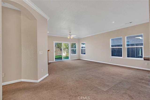 empty room featuring ornamental molding, carpet flooring, visible vents, and baseboards