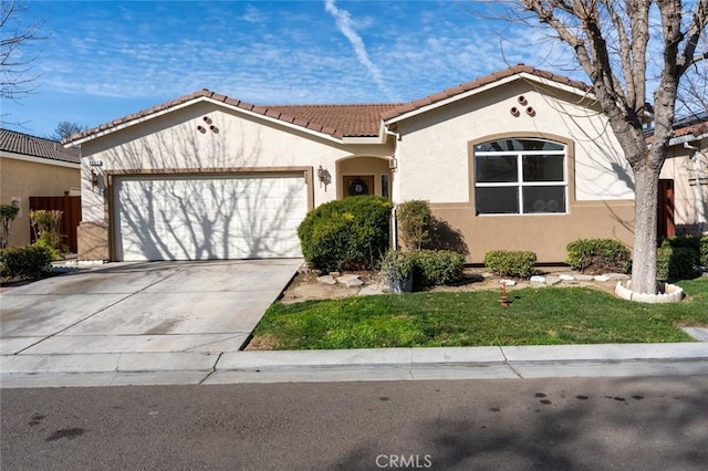 view of front of house featuring a garage, concrete driveway, stucco siding, a tile roof, and a front yard