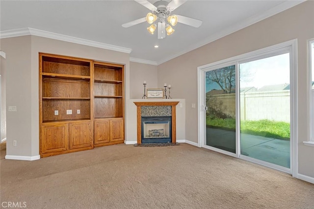 unfurnished living room with light carpet, baseboards, a fireplace with flush hearth, ceiling fan, and ornamental molding