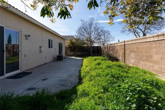 view of yard featuring a patio area and a fenced backyard