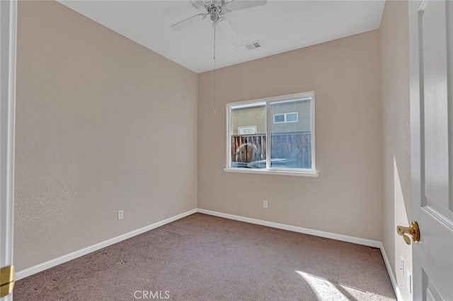 empty room featuring visible vents, carpet floors, a ceiling fan, and baseboards