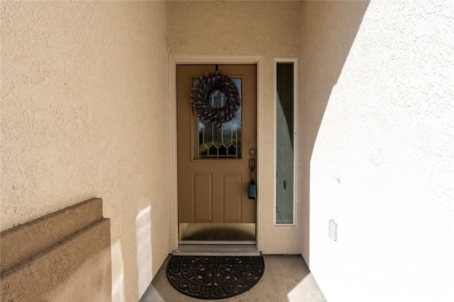 property entrance featuring stucco siding