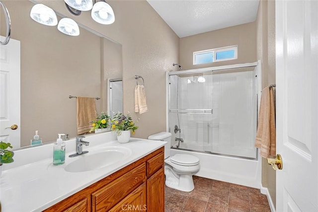 full bath featuring toilet, shower / bath combination with glass door, and vanity