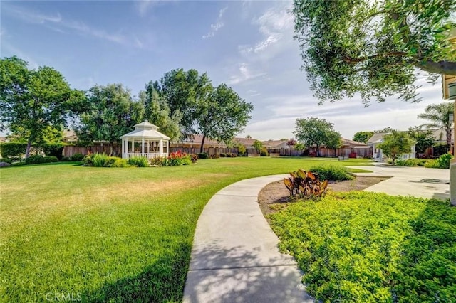 view of home's community featuring a gazebo, a lawn, and fence