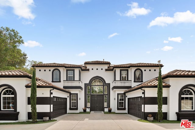 mediterranean / spanish home with a balcony