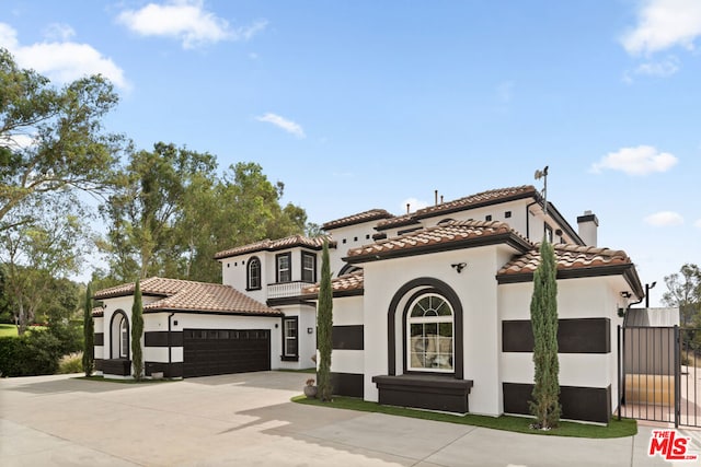 mediterranean / spanish-style home with a garage