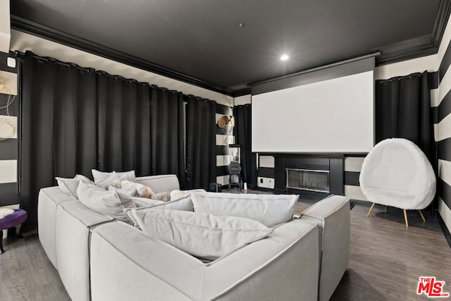 cinema room featuring wood-type flooring and crown molding