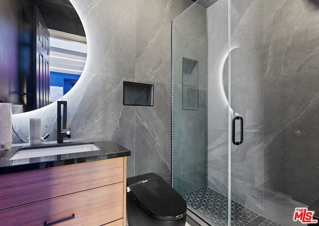 bathroom featuring vanity, walk in shower, and tile walls