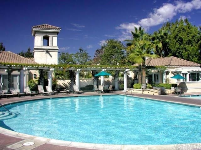 view of pool with a patio and a pergola