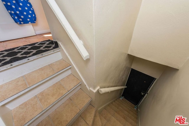 staircase with tile patterned flooring